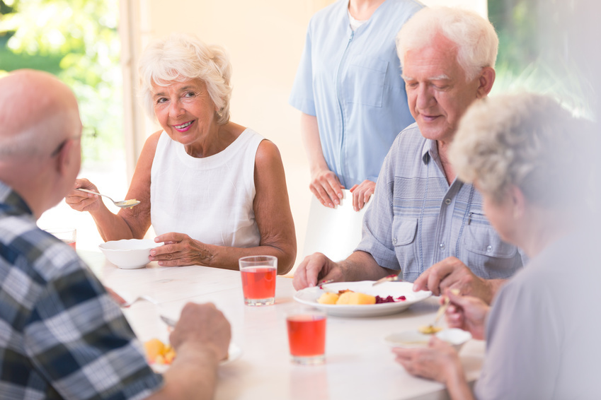 Smiling senior woman eating soup Smiling senior woman eating soup